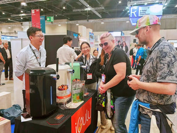 iGulu First Showcase in the Berlin International Consumer Electronics Fair with attendees engaging at the booth.