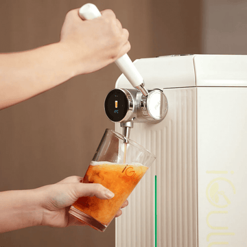 Enjoying a refreshing drink with the iGulu NFL Game Day Brew Bundle's smart brewer.