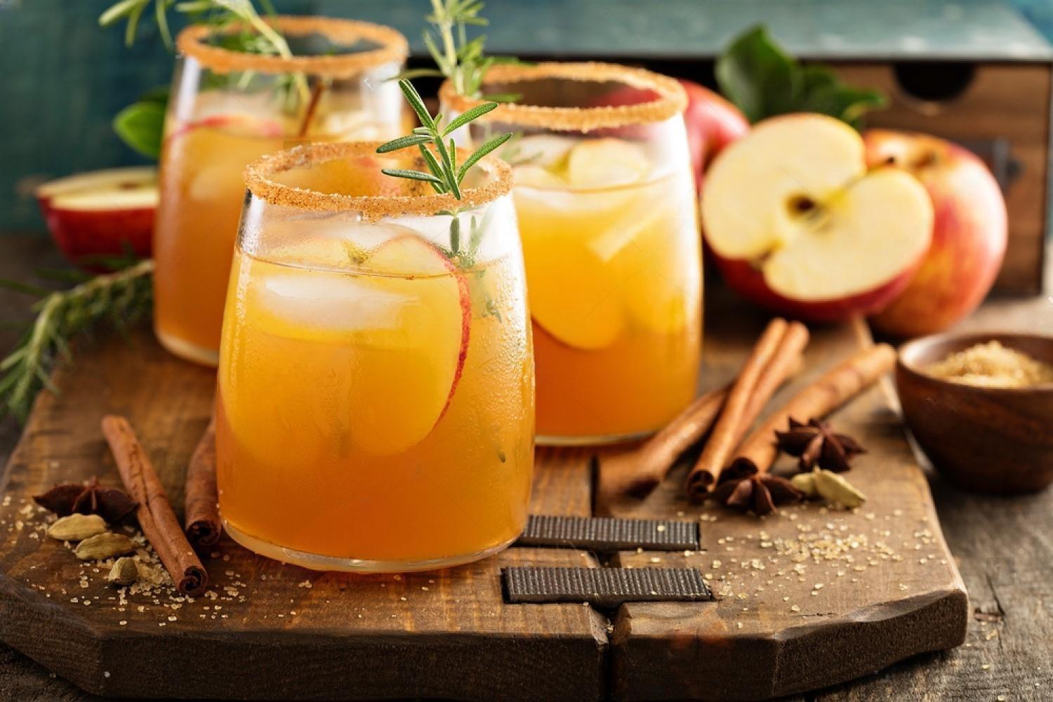How to Brew: Mike’s “Stupid Simple” Hard Cider with refreshing apple-flavored drinks garnished with herbs.