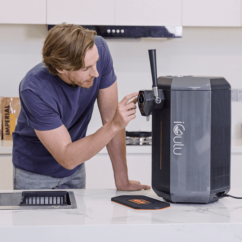 iGulu S1 Cyber Week Starter Home Brewer Smart Bundle in use with a user checking the tap.